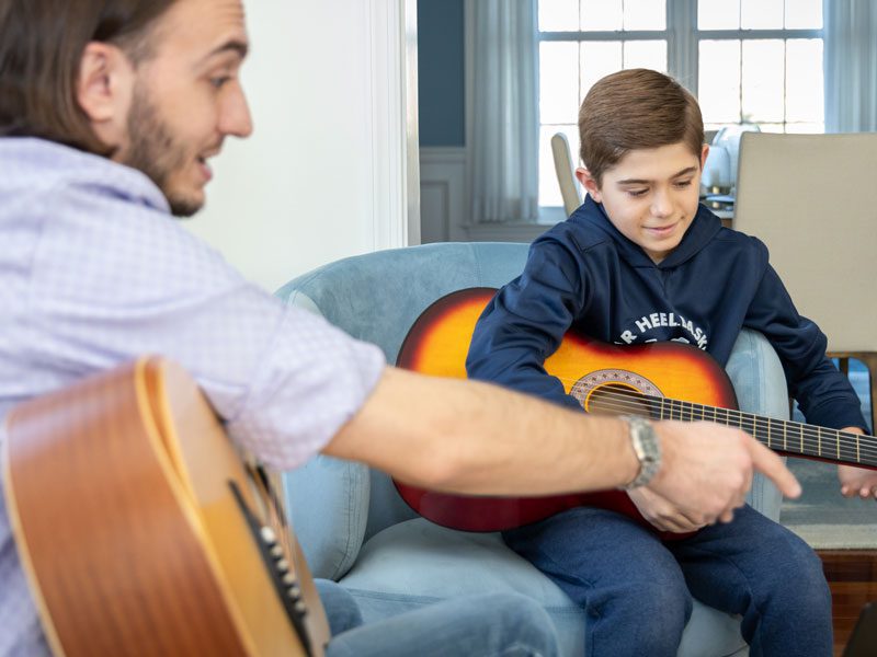 Danton adding some notes to a music sheet during a private music lesson near West Chester, PA.