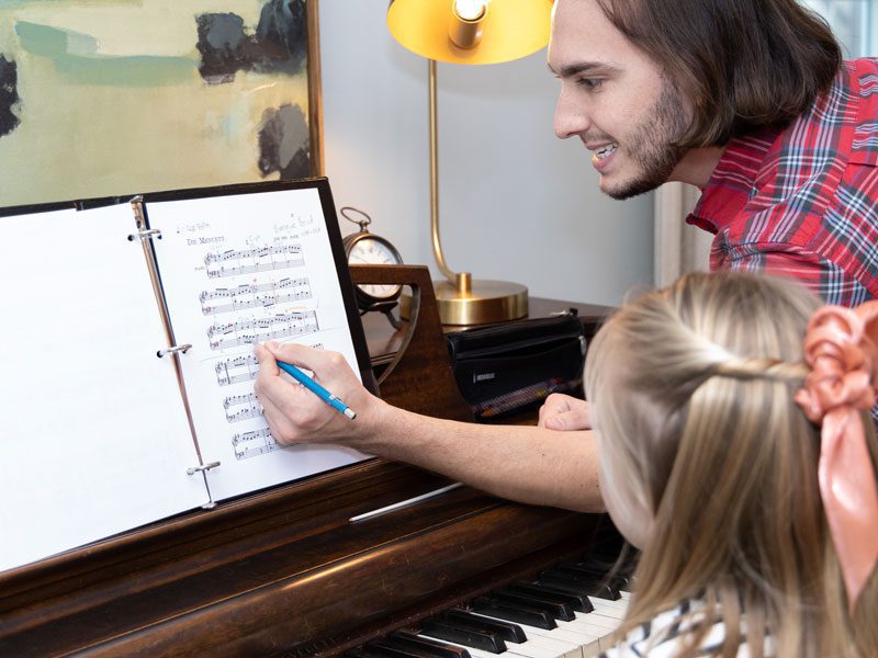 Danton adding some notes to a music sheet during a private music lesson near West Chester, PA.